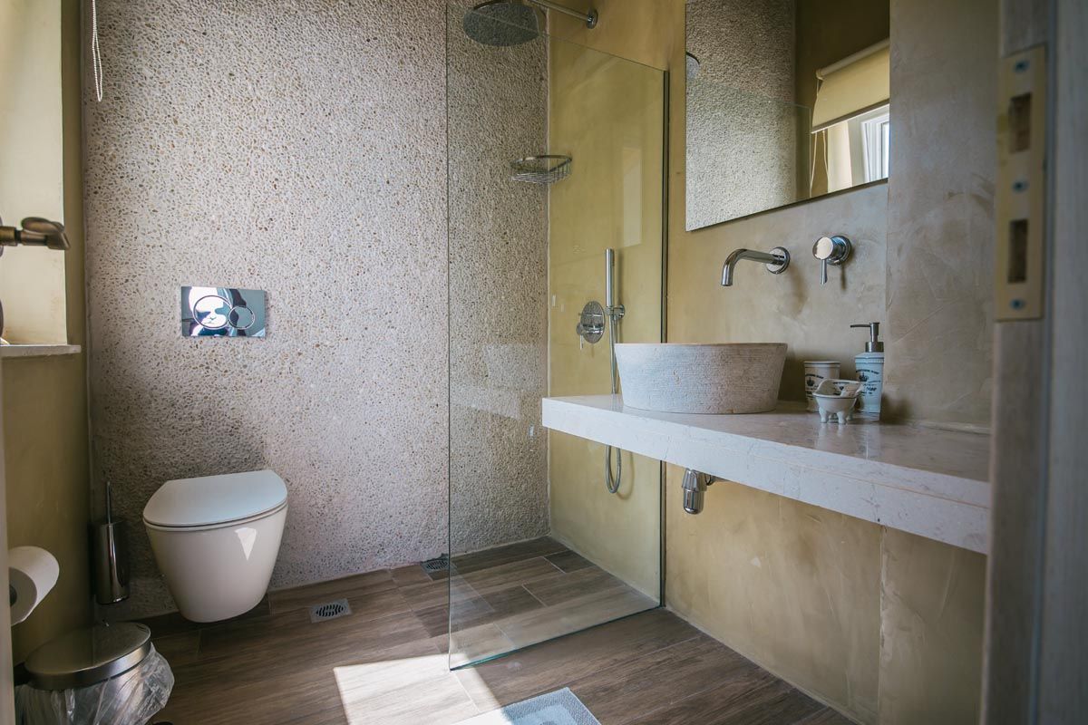 Bathroom at Perla House with walk-in shower and marble basin