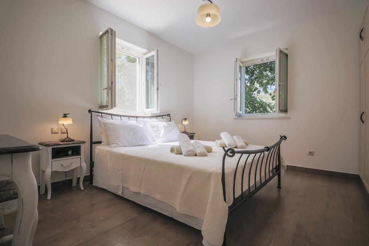 Double bedroom at Mistral House with white linen and shuttered windows