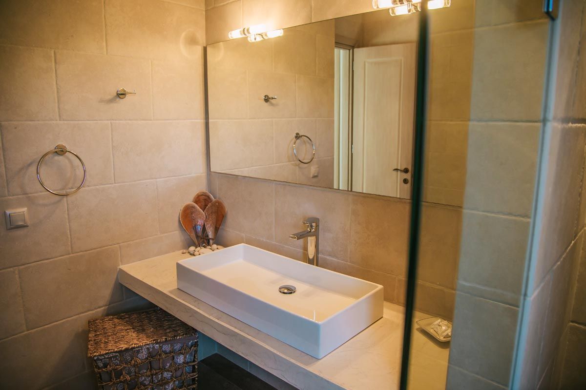 Bathroom at Mistral House with a marble basin and mirrored cabinet
