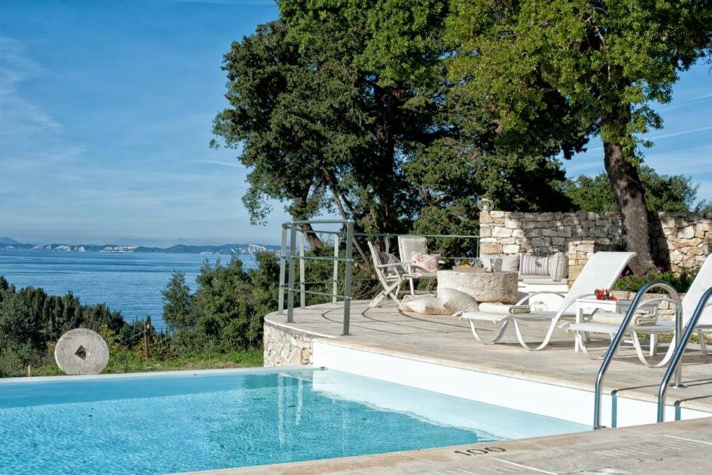 Pool and shaded lounge terrace at Mistral House looking out over the Ionian Sea