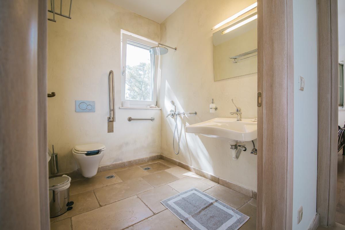 Bathroom at Mistral House with a stone washstand and walk-in shower