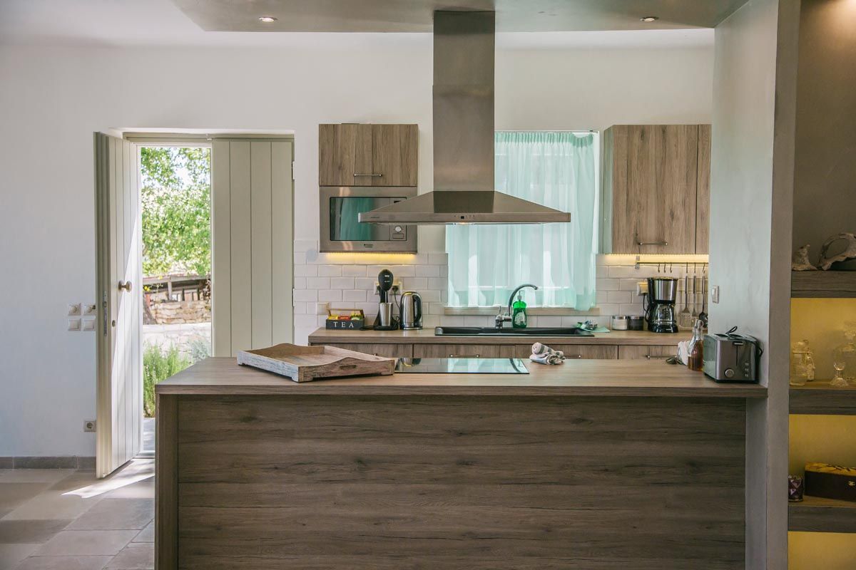 Kitchen at Perla House with a timber island and modern appliances