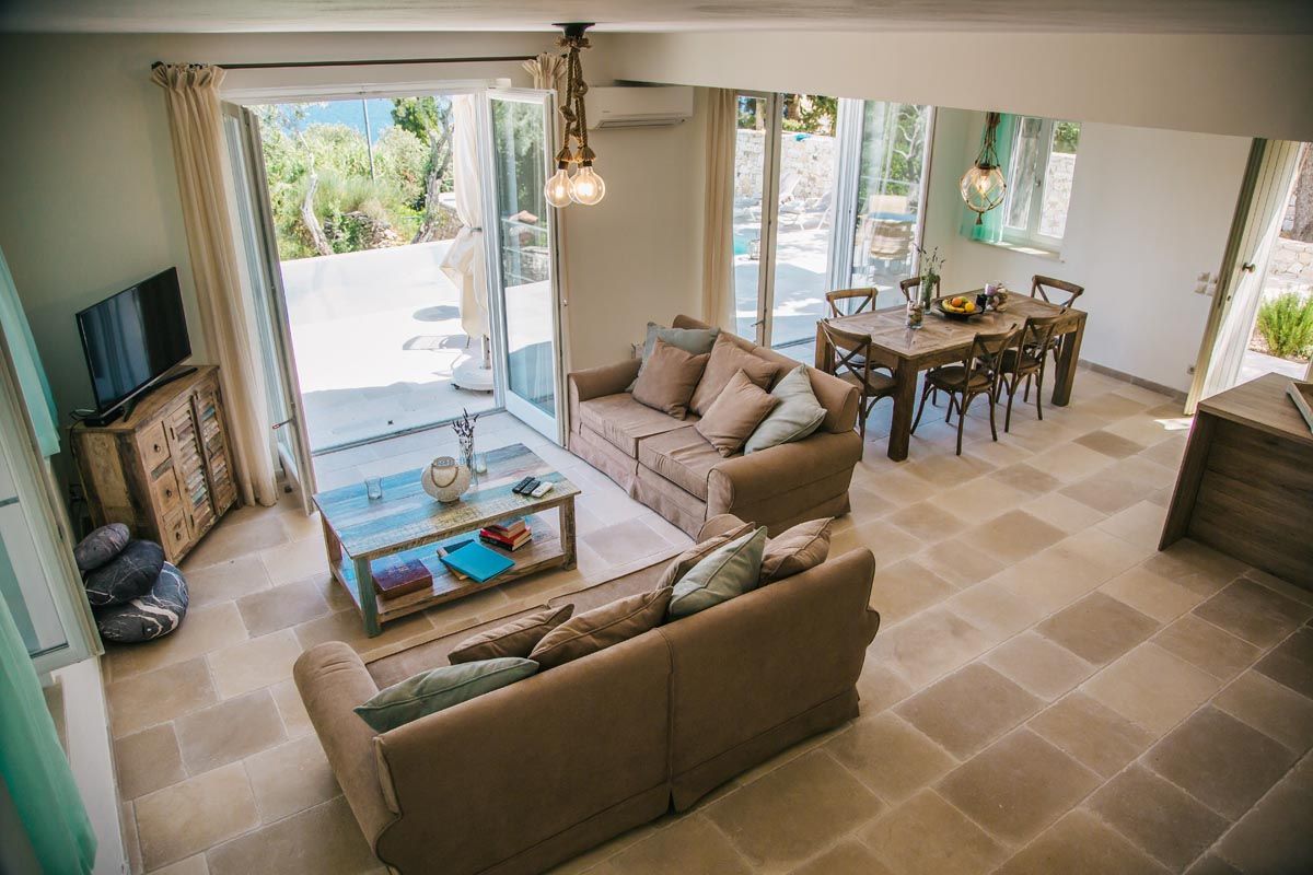 Living room at Perla House with glass doors opening onto the terrace