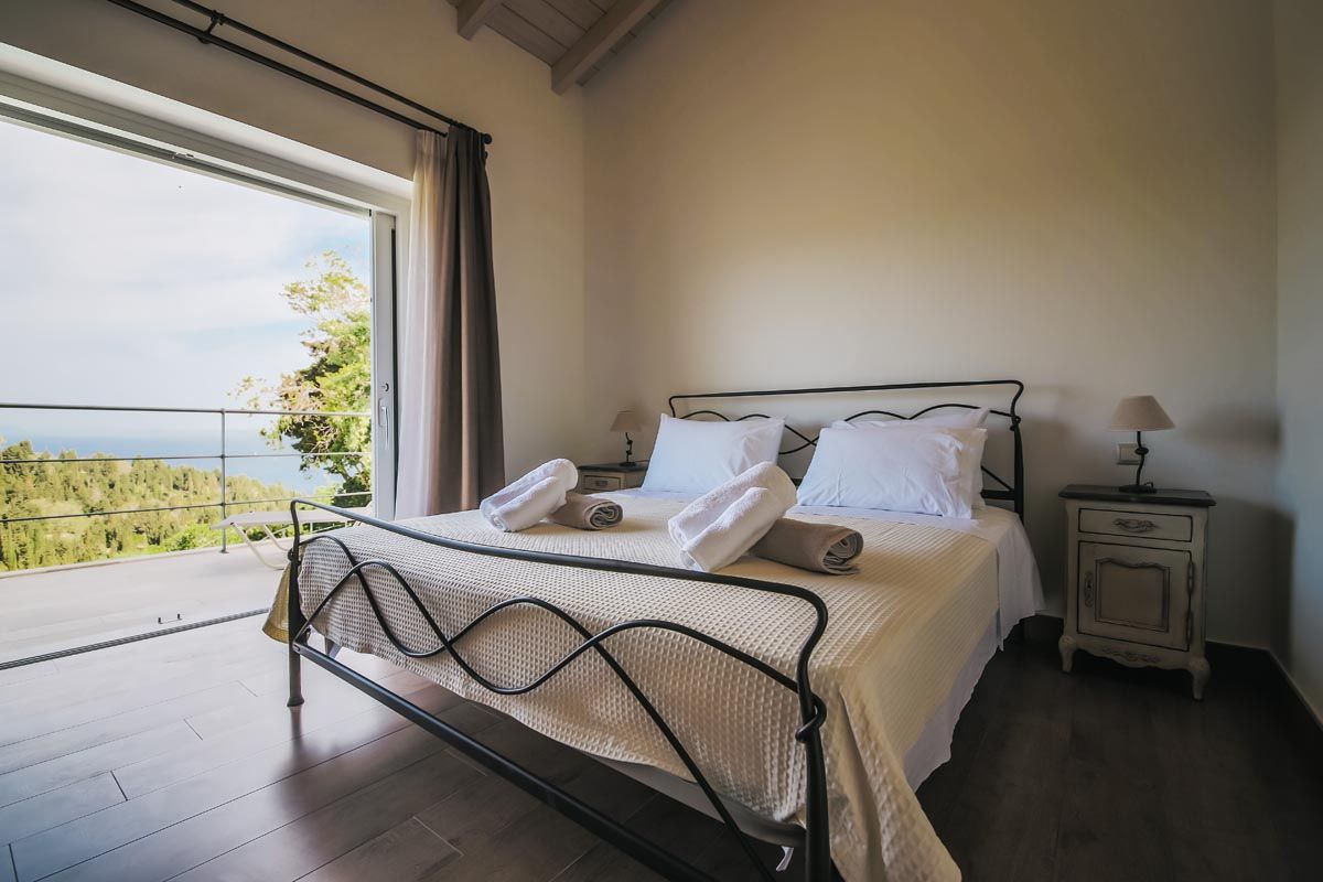 Bedroom at Mistral House with the sea framed in the window