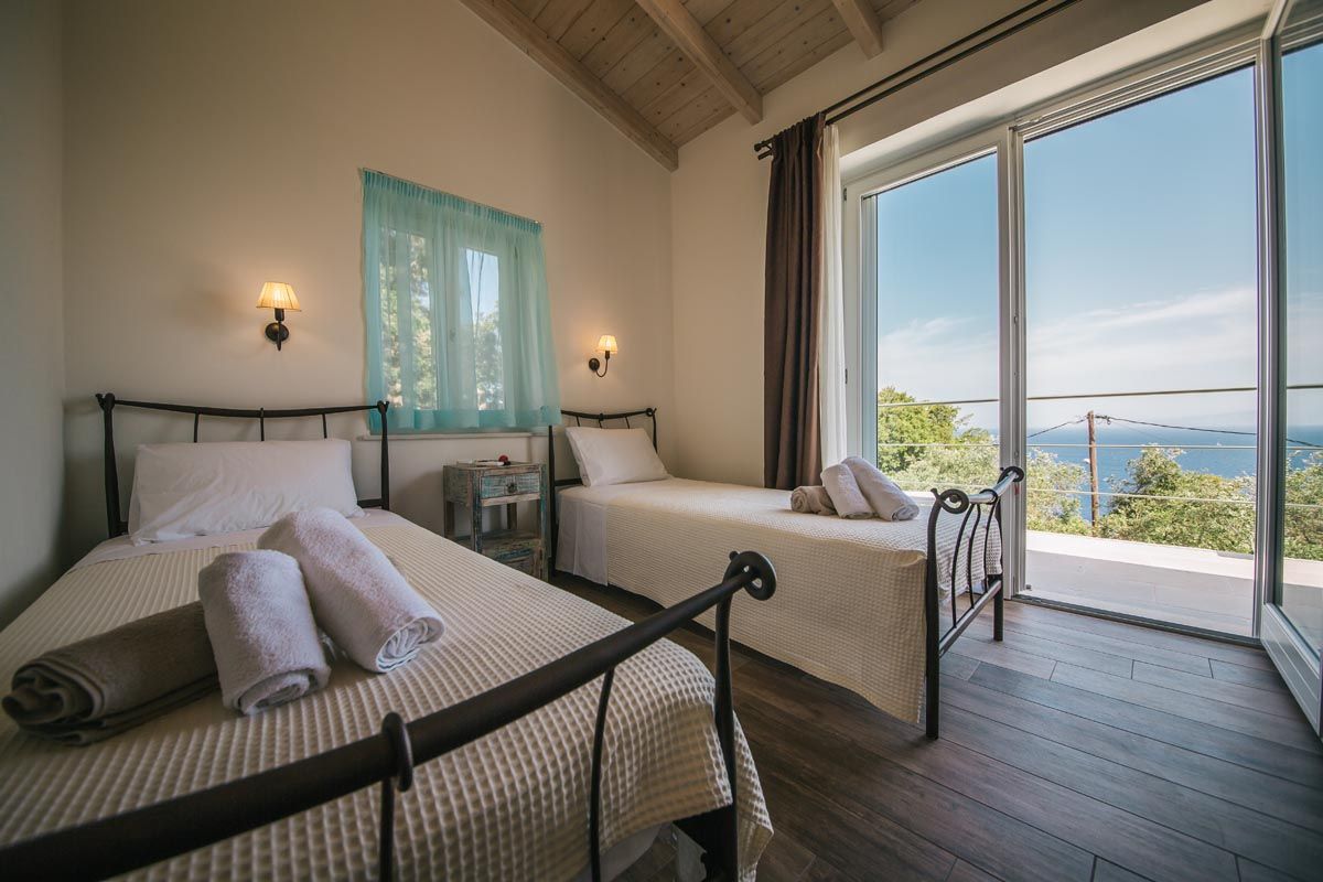 Twin bedroom at Perla House with pale turquoise shutters